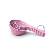 تحميل الصورة في عارض المعرض، A set of four nested measuring cups in a pastel pink color, arranged diagonally on a clean white background.