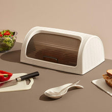 Load image into Gallery viewer, White bread box on a table with a knife, cutting board, and food items.