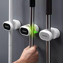 Load image into Gallery viewer, Two wall-mounted broom mop holders with self-adhesive stickers. One is holding a broom, and the other is holding a mop.
