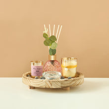 Load image into Gallery viewer, Decorative items including a diffuser, candles, and a small plant on a wooden tray against a beige background.