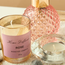 Load image into Gallery viewer, Rose scented candle and diffuser on a textured surface
