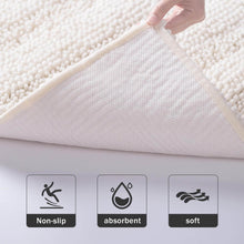 Load image into Gallery viewer, White chenille bath mat folded back to show its textured underside