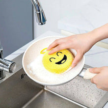 Load image into Gallery viewer, Yellow smiley face sponge being washed in a sink.