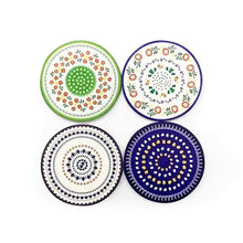 Load image into Gallery viewer, Four decorative ceramic plates with different patterns on a white background
