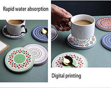 Load image into Gallery viewer, Coasters with digital printed designs on a table with a cup of coffee.