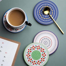 Load image into Gallery viewer, Set of colorful coasters with a cup of coffee and spoon on a green surface