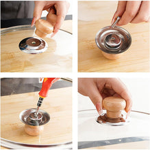 تحميل الصورة في عارض المعرض، Four-panel demonstration showing a metal lid lifter tool used to remove and lift a glass pot lid. The tool has a silver metal circular base with a wooden handle and a small hook.