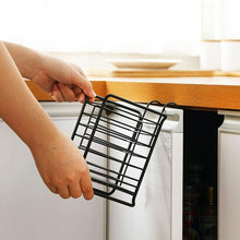 تحميل الصورة في عارض المعرض، Person holding a black wire rack over a kitchen cabinet.