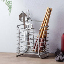 تحميل الصورة في عارض المعرض، Silver utensil holder with cutlery and chopsticks on a wooden surface.