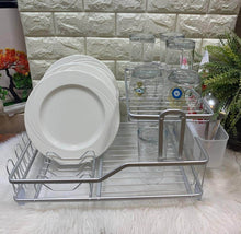 تحميل الصورة في عارض المعرض، Dish rack with plates and glasses on a stone wall background