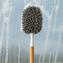 تحميل الصورة في عارض المعرض، Cleaning brush with gray bristle head against a soapy water background