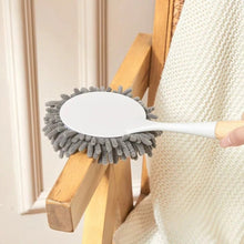 تحميل الصورة في عارض المعرض، Cleaning brush with gray bristle head held by a person against a neutral background