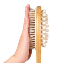 تحميل الصورة في عارض المعرض، Hand holding a dry brush with wooden handle and natural bristles on a white background