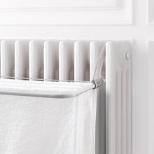 تحميل الصورة في عارض المعرض، White radiator with a towel hanging on it against a white wall