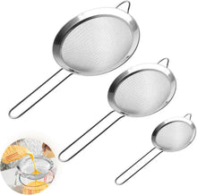 Load image into Gallery viewer, A set of three stainless steel fine mesh strainers with long wooden handles, in varying sizes, displayed alongside a visual representation of one strainer being used to strain pasta.