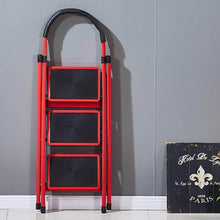 Load image into Gallery viewer, Red step ladder against a gray wall with a decorative sign in the corner.