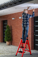 Load image into Gallery viewer, Man on a red step ladder installing or adjusting something on a ceiling.