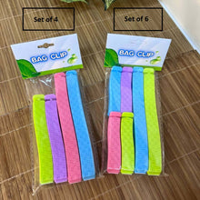 Load image into Gallery viewer, Two packages of bag clips, one set of four and one set of six, on a wooden surface.