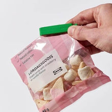 Load image into Gallery viewer, Hand holding a package of Lördagsgodis candy with strawberry and vanilla flavor, branded as IKEA.