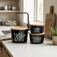 تحميل الصورة في عارض المعرض، Three black canister storage containers with bamboo lids are arranged on a kitchen counter. Each canister has white script lettering that reads 'Just for us' with a small floral or leaf motif.