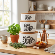 تحميل الصورة في عارض المعرض، Three nested white ceramic canisters with light wood lids, each printed with the phrase 'Perfect life' in black script and decorative flourishes, shown on a plain white background.