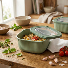Load image into Gallery viewer, Green food storage container with pasta inside on a gray background