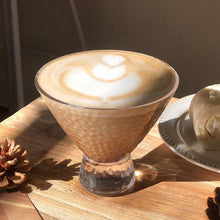 Load image into Gallery viewer, Cappuccino in a glass with latte art on a wooden table