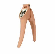 Load image into Gallery viewer, A beige-colored heavy-duty stainless steel garlic press with a comfortable grip for ease of use.