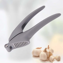 تحميل الصورة في عارض المعرض، Gray garlic press with garlic cloves on a light background