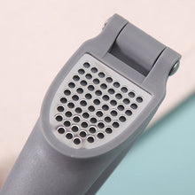 Load image into Gallery viewer, Gray kitchen grater on a light pink background