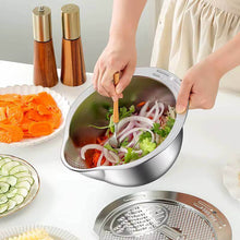 Load image into Gallery viewer, Person preparing a salad using a stainless steel salad spinner on a kitchen counter.