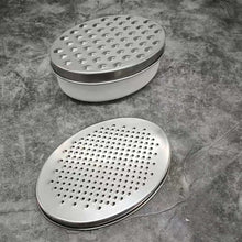 تحميل الصورة في عارض المعرض، Two metal shower heads with perforated designs on a stone surface