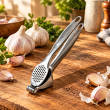 Load image into Gallery viewer, Metallic garlic press on a white background
