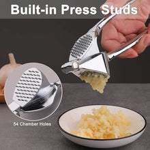 Load image into Gallery viewer, Garlic press with built-in press studs, showing minced garlic and close-up of 54 chamber holes.