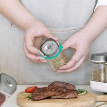 Load image into Gallery viewer, Shakers - Glass Spice seasoning jars Set of 4 with Plastic Lids & Holder being used to season meat.