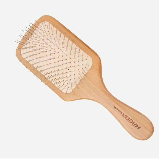 Wooden hairbrush with bristle head on a white background