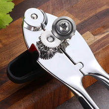 Load image into Gallery viewer, Heavy-duty stainless steel can opener with sharp cutting wheels and ergonomic non-slip handle on a wooden surface.