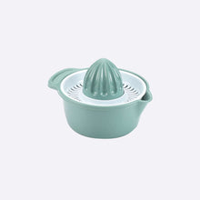 تحميل الصورة في عارض المعرض، Mint green manual juicer on a light gray background