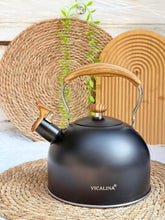 Load image into Gallery viewer, Black kettle with wooden handle on a woven mat
