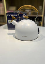 Load image into Gallery viewer, White kettle with wooden handle on a white surface, Vicalina brand visible