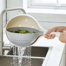 تحميل الصورة في عارض المعرض، Person washing broccoli in a white colander under running water in a kitchen.