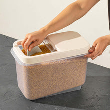 تحميل الصورة في عارض المعرض، A person is opening a large transparent plastic storage container filled with grains, using a slide lid.