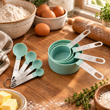 تحميل الصورة في عارض المعرض، Set of measuring cups and spoons on a wooden cutting board with a gray concrete background