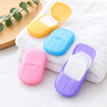 تحميل الصورة في عارض المعرض، Colorful fabric softener sheets in plastic cases on a white towel with a wooden board in the background.