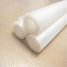 Load image into Gallery viewer, Two rolls of white non-slip shelf liner placed on a textured surface.