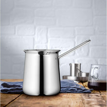 Load image into Gallery viewer, Stainless steel milk frothing pitcher on a wooden surface with a white brick wall background