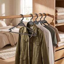 Load image into Gallery viewer, Set of black hangers with a Dukki label on a white background