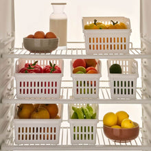 تحميل الصورة في عارض المعرض، Fruit and vegetable storage shelves with various produce in white baskets and bowls.