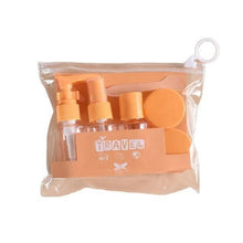 Load image into Gallery viewer, Set of travel-sized bottles with orange caps in a clear bag on a white background