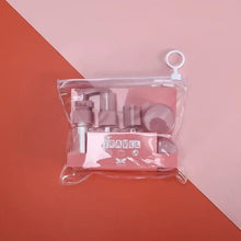 Load image into Gallery viewer, Clear travel pouch with cosmetic items on a pink and orange background